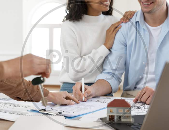 smiley couple signing contract new house