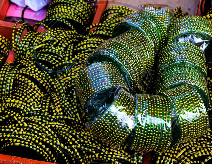 Stock Photo Of Bunch Of Green Color Bangles Made Of Glass Kept On Roadside For Sale In Sunny Afternoon At Indian Market ,Focus On Glass Bangles.