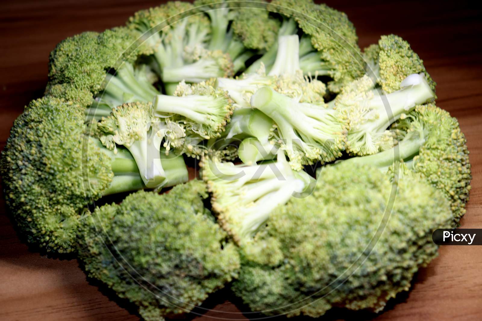 Sliced Broccoli Stock On Wooden Table