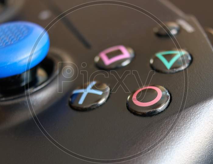 Krakow, Poland- April 13, 2021: A Close Up Extreme Selective Focus Of The Iconic Play Station Buttons On A Wireless Controller. The Square, Cross, Triangle And Circle Button. Macro Shot.