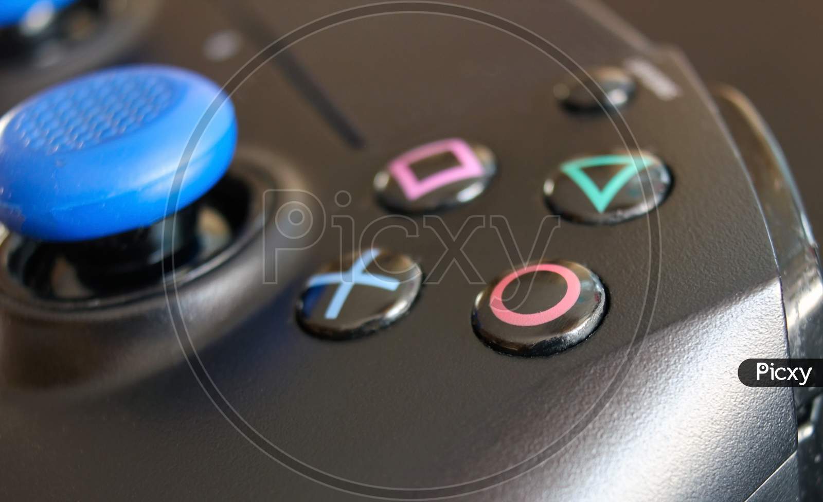 Krakow, Poland- April 13, 2021: A Close Up Extreme Selective Focus Of The Iconic Play Station Buttons On A Wireless Controller. The Square, Cross, Triangle And Circle Button. Macro Shot.