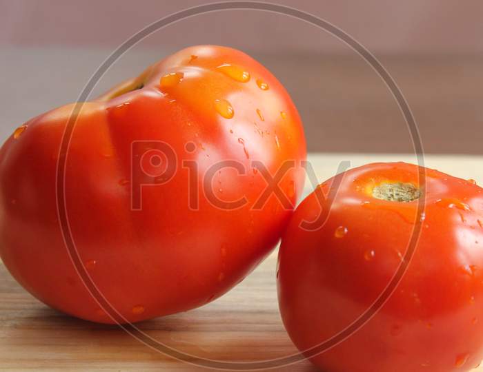 Tomatos On Top Of The Table  Stock Photo