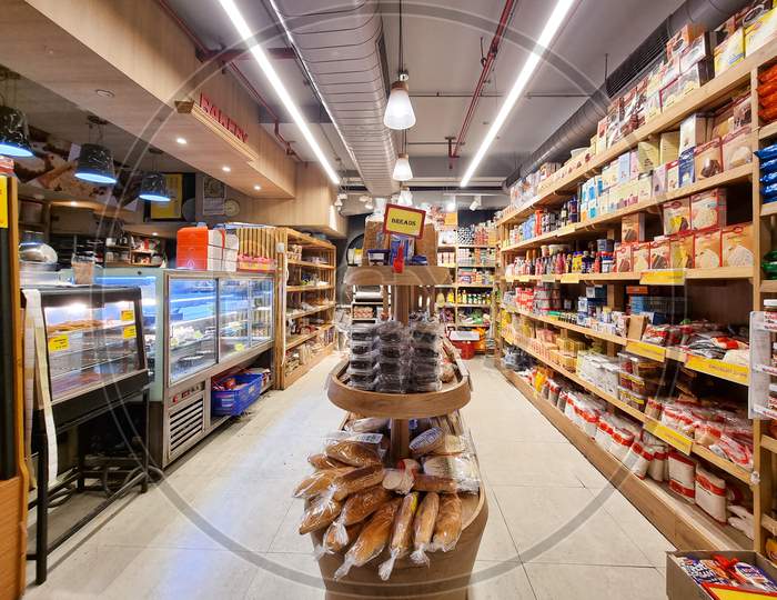 Fmcg Products With Staples Like Bread And Frozen Items On Shelves In A Super Hyper Market With Colorful Packaging Of Ready To Eat Quick To Prepare From Companies Like Nestle, Unilever, Danone, General Mills
