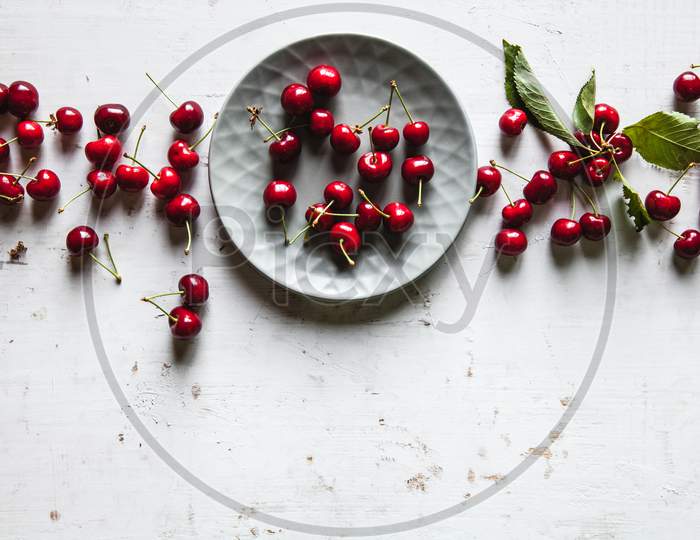 Sweet Cherries In A Plate On An Old White Background, Healthy Food, Fruits
