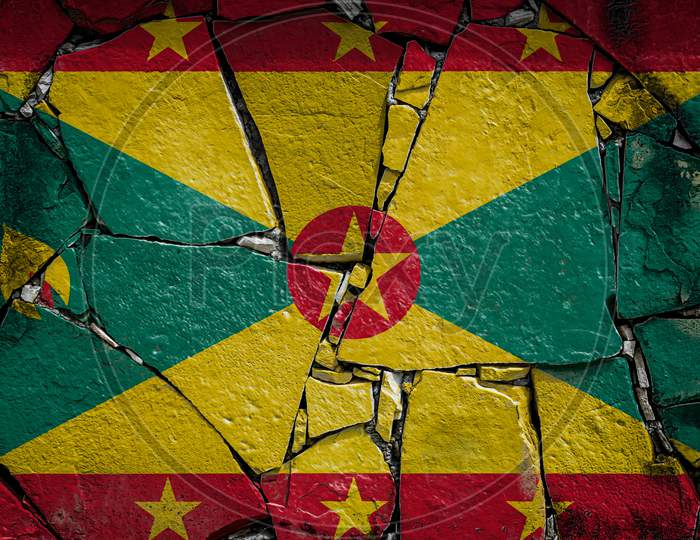 National Flag Of Grenada
 Depicting In Paint Colors On An Old Stone Wall. Flag  Banner On Broken  Wall Background.