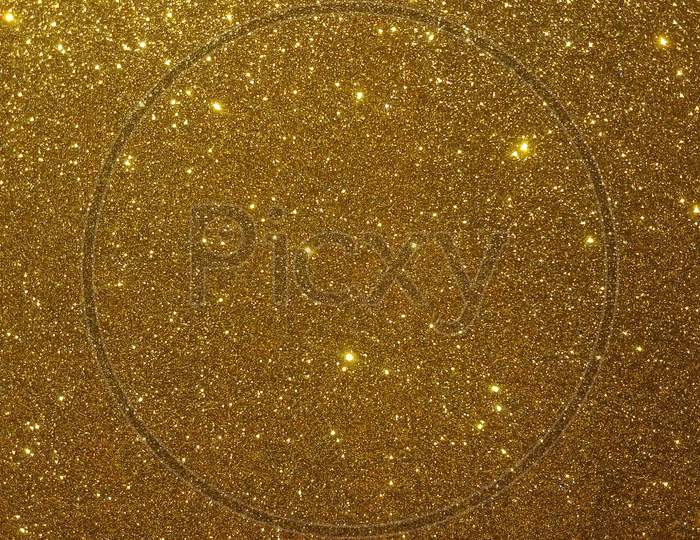 Glitter textured gold or yellow shaded background wallpaper.