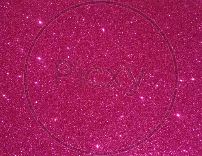 Glitter textured pink shaded background wallpaper.