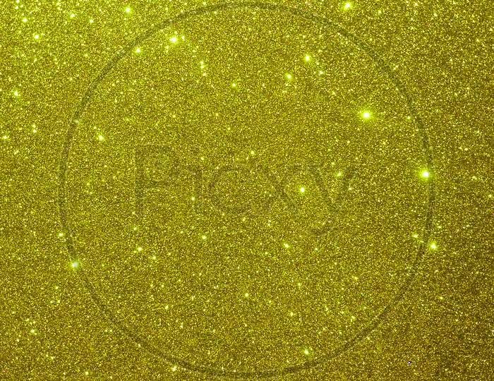 Glitter textured gold or yellow shaded background wallpaper.
