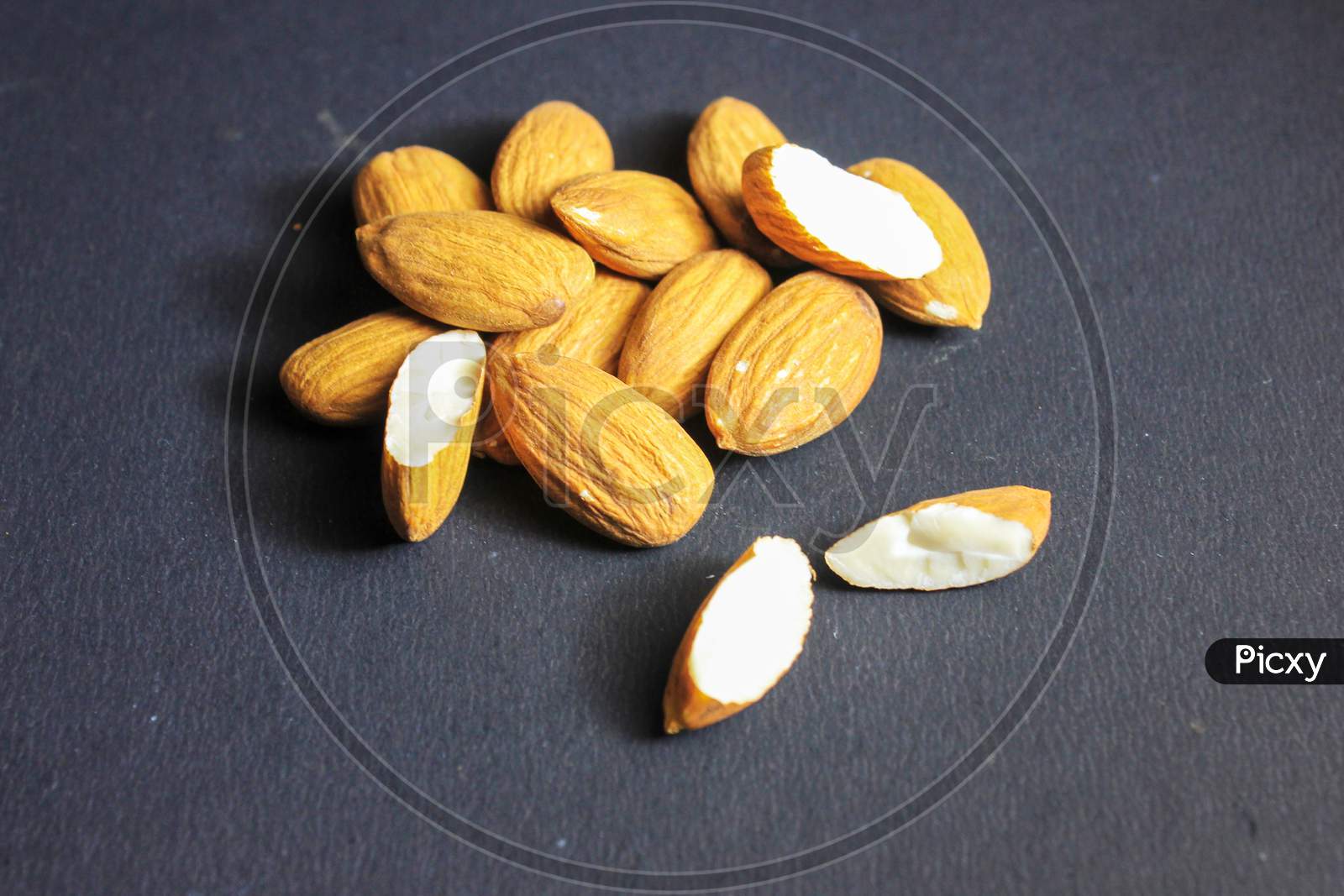 Close Up Of Almonds On Dark Background