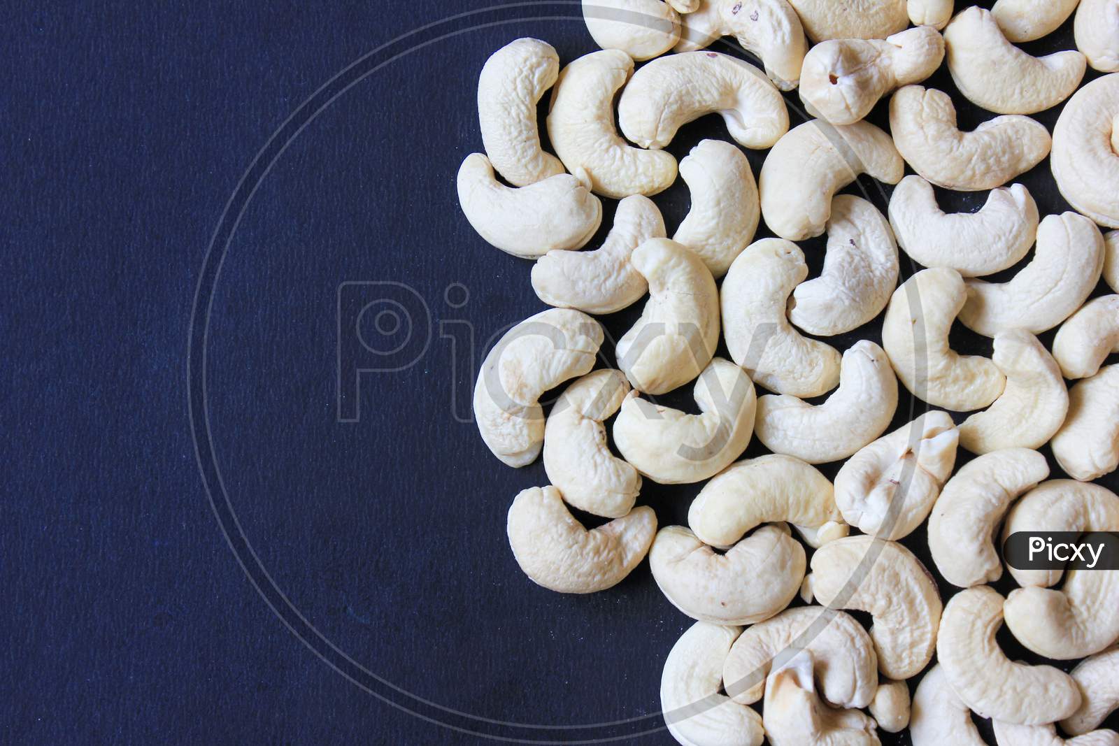 Close Up Of Cashew Nut On Dark Background