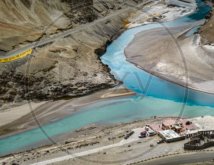 Aerial View Of A River Meeting Another River With Different Color At A Sangam In Indus Valley In Ladakh.