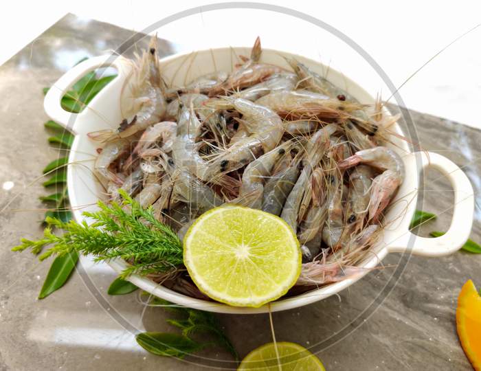 Fresh White Prawns Decorated In A White Bowl With Herbs And Fruits.Selective Focus.