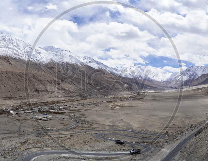 Panorama Shot Of Mountains And Blue Sky With Covered Clouds, Barren And Deserted Land In Ladakh.