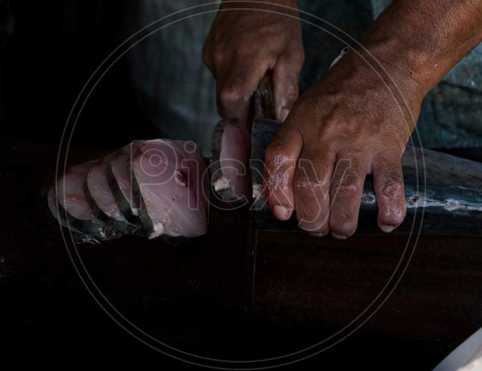 Human Hand Slicing The King Mackerel Fish, Mangalore, India