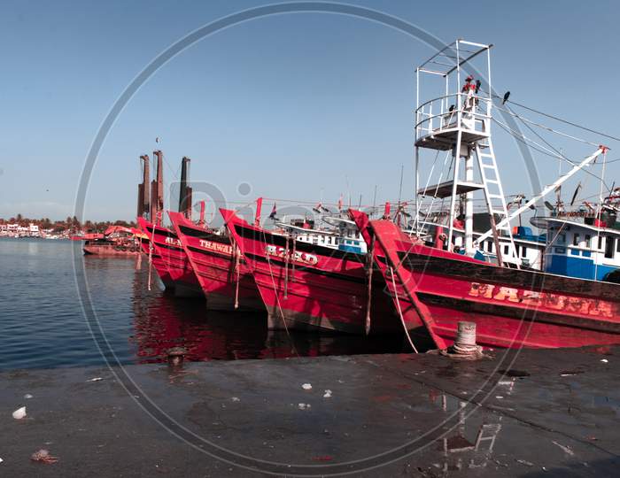"Mangalore, Karnataka, India - April 2Nd 2021 : Landscape Shot Of Mangalore Fishing Ships Resting On Their Yard"