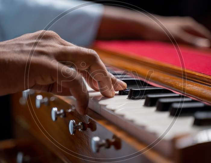 Close Up Of Hands Playing Harmonium Or Reed Organ An Indian Classical Music Instrument.
