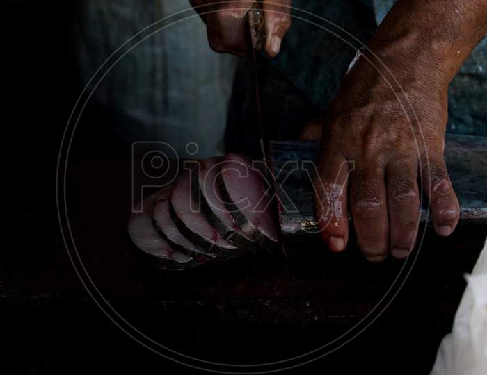 Human Hand Slicing The King Mackerel Fish, Mangalore, India