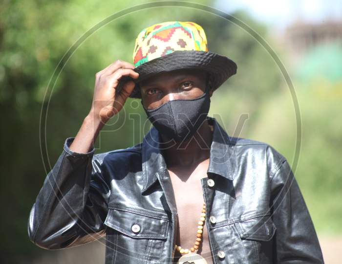 Covid 19 African young man in his mask black keep your mask on stay safe