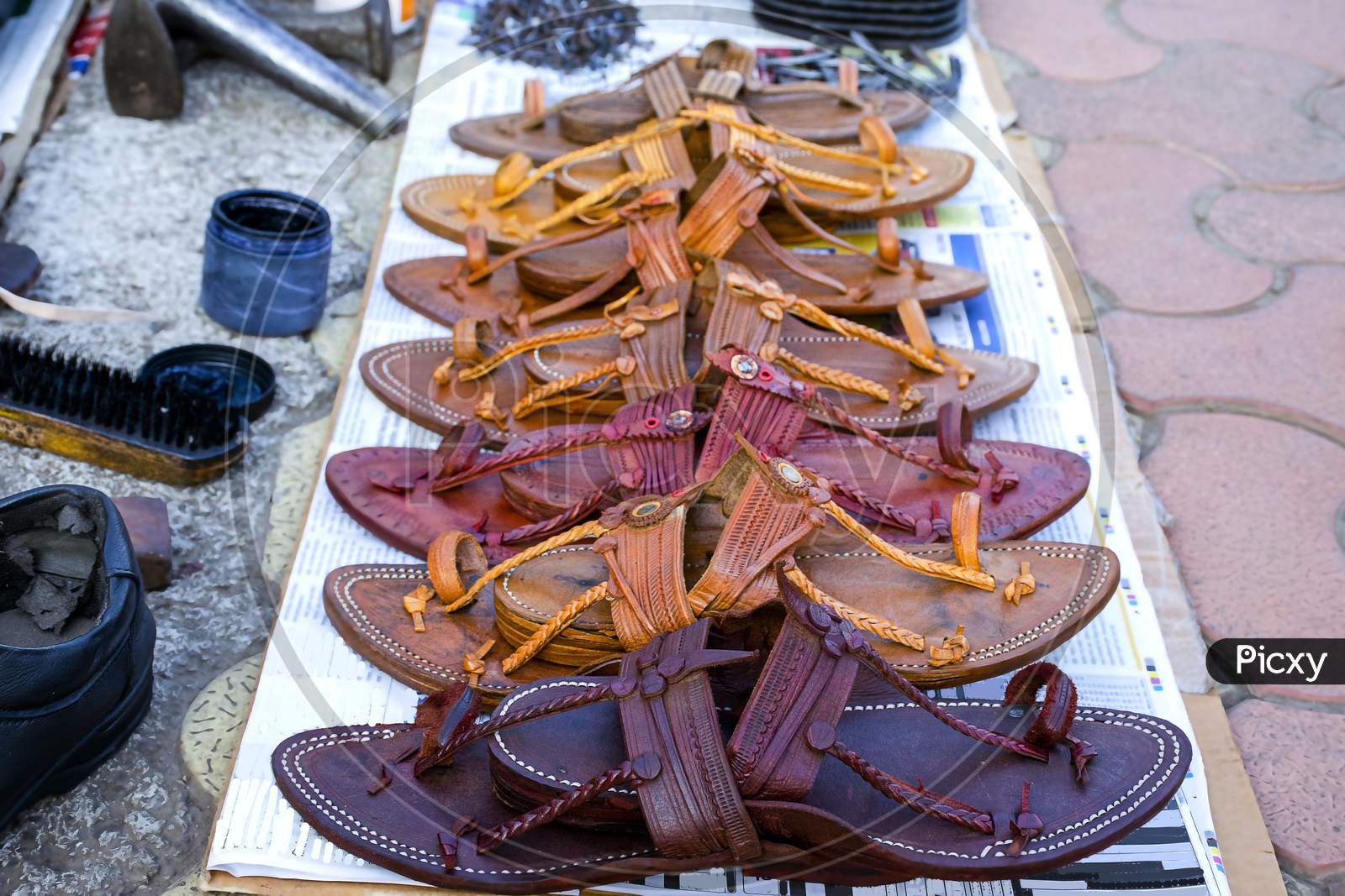 Stock Photo Of Popular And Traditional Kolhapuri Chappal Kept On Roadside For Sale At Indian Market.It Is Handmade Leather Chappal With Unique Design And Color.