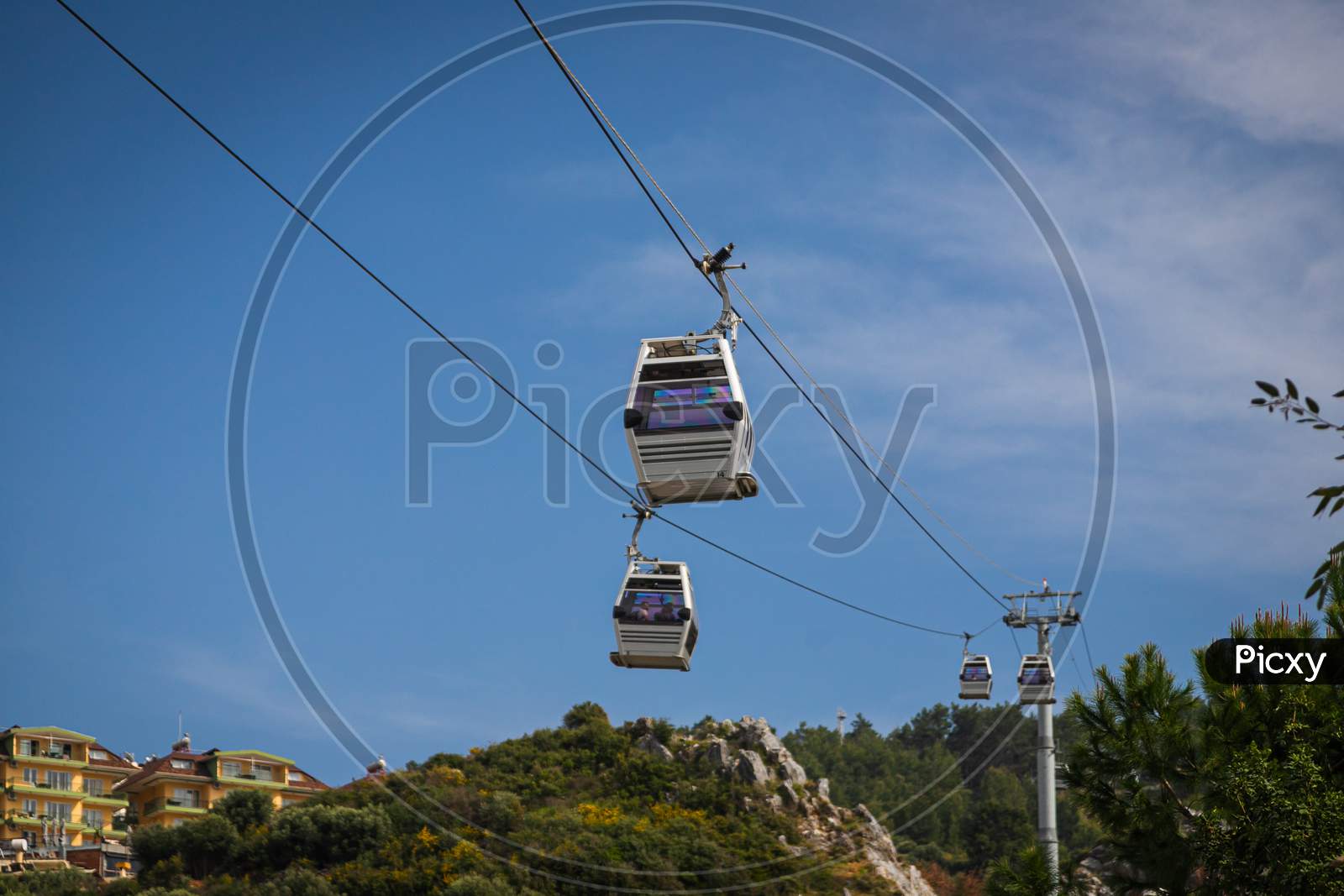 Rope Way Over Cloudy Blue Sky. Funicular Cabins And Aerial City Skyline Panoramic View In Turkey