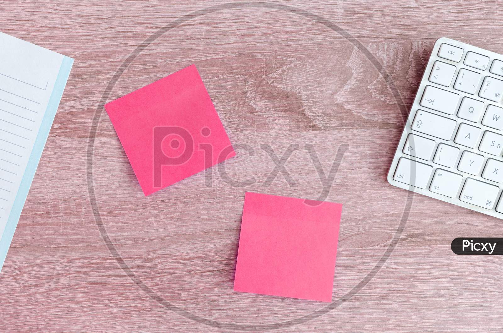 pink colour sticky notes on table
