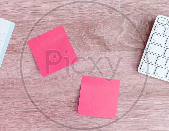 pink colour sticky notes on table