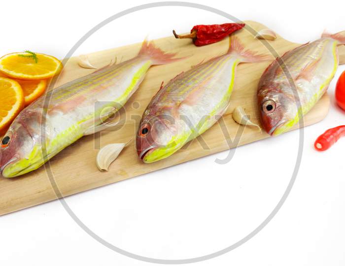 Fresh Pink Perch Fish With Ingredients Like Lemon,Curry Leaves,Chilli,Selective Focus.White Background.