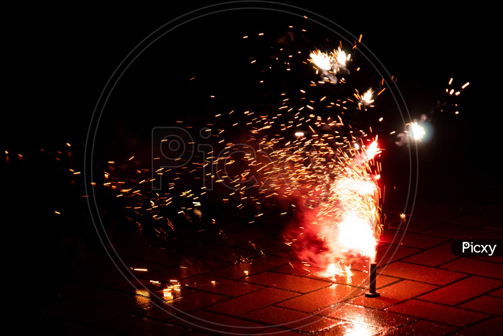 Colorful fireworks illuminates the silvester night with firecrackers, bangers and explosive pyrotechnics and fountains of light to celebrate into a happy new year on a silvester party with friends