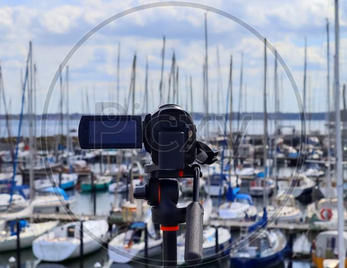 Selective Focus View At A Camera Filming At A Yacht Port In Kiel In Germany