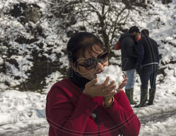 Tourist Trying To Eat Snow Just After Snowfall.