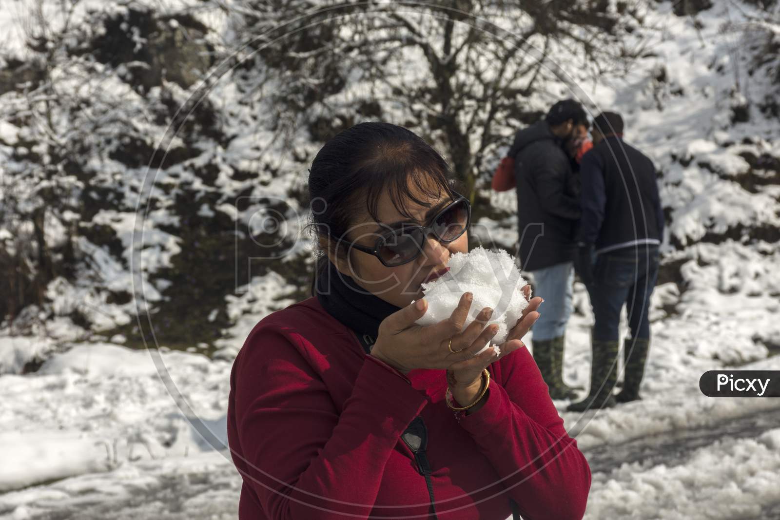 Tourist Trying To Eat Snow Just After Snowfall.