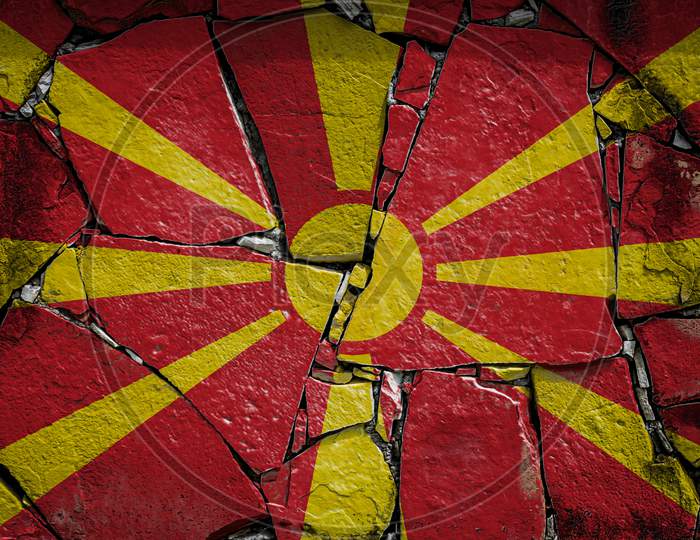 National Flag Of Macedonia Depicting In Paint Colors On An Old Stone Wall. Flag  Banner On Broken  Wall Background.