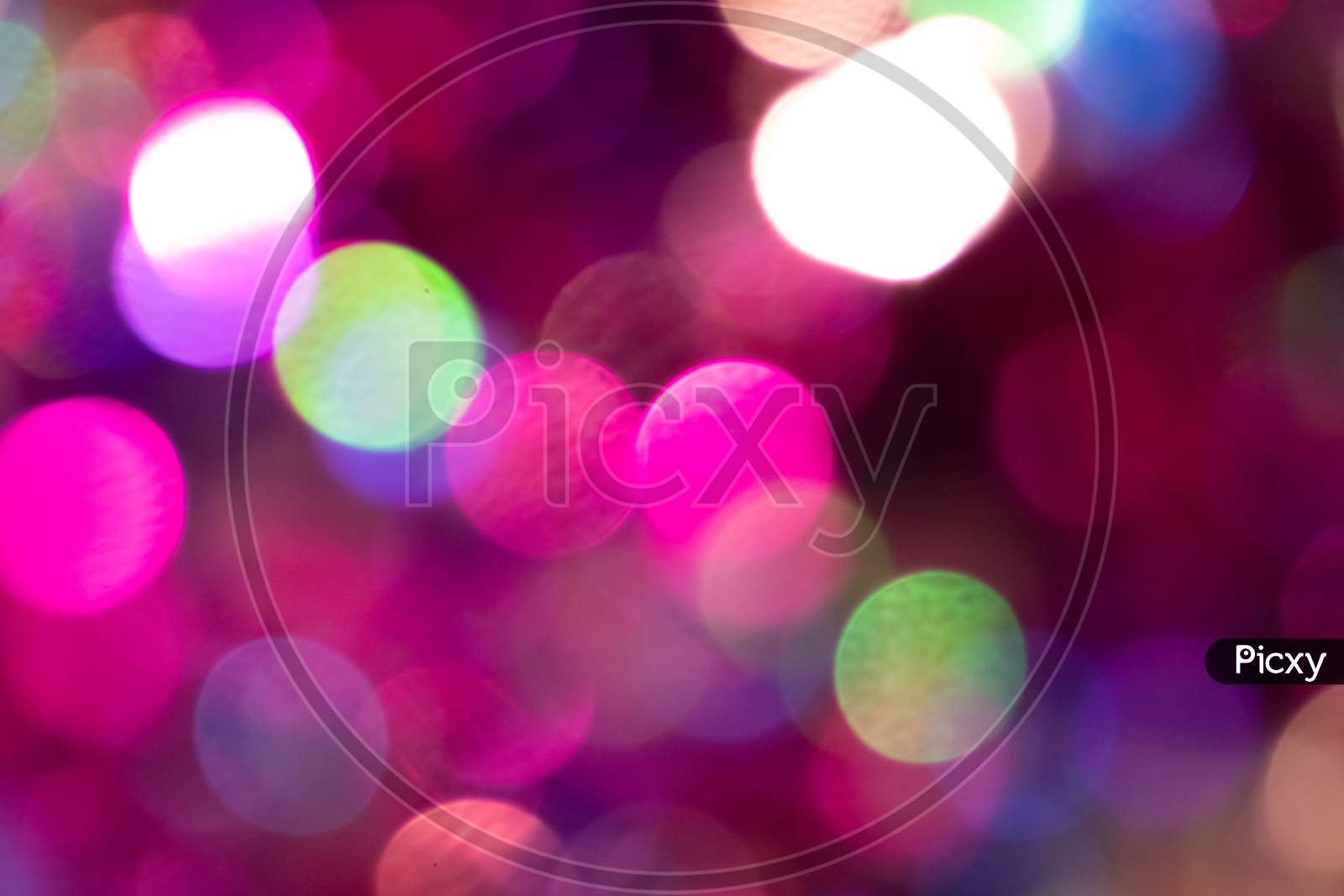 Festive colorful bokeh background with psychedelic colorful sparkles and colorful dots as perfect background for silvester, celebration and happy new year annotations as beautiful blurred glow