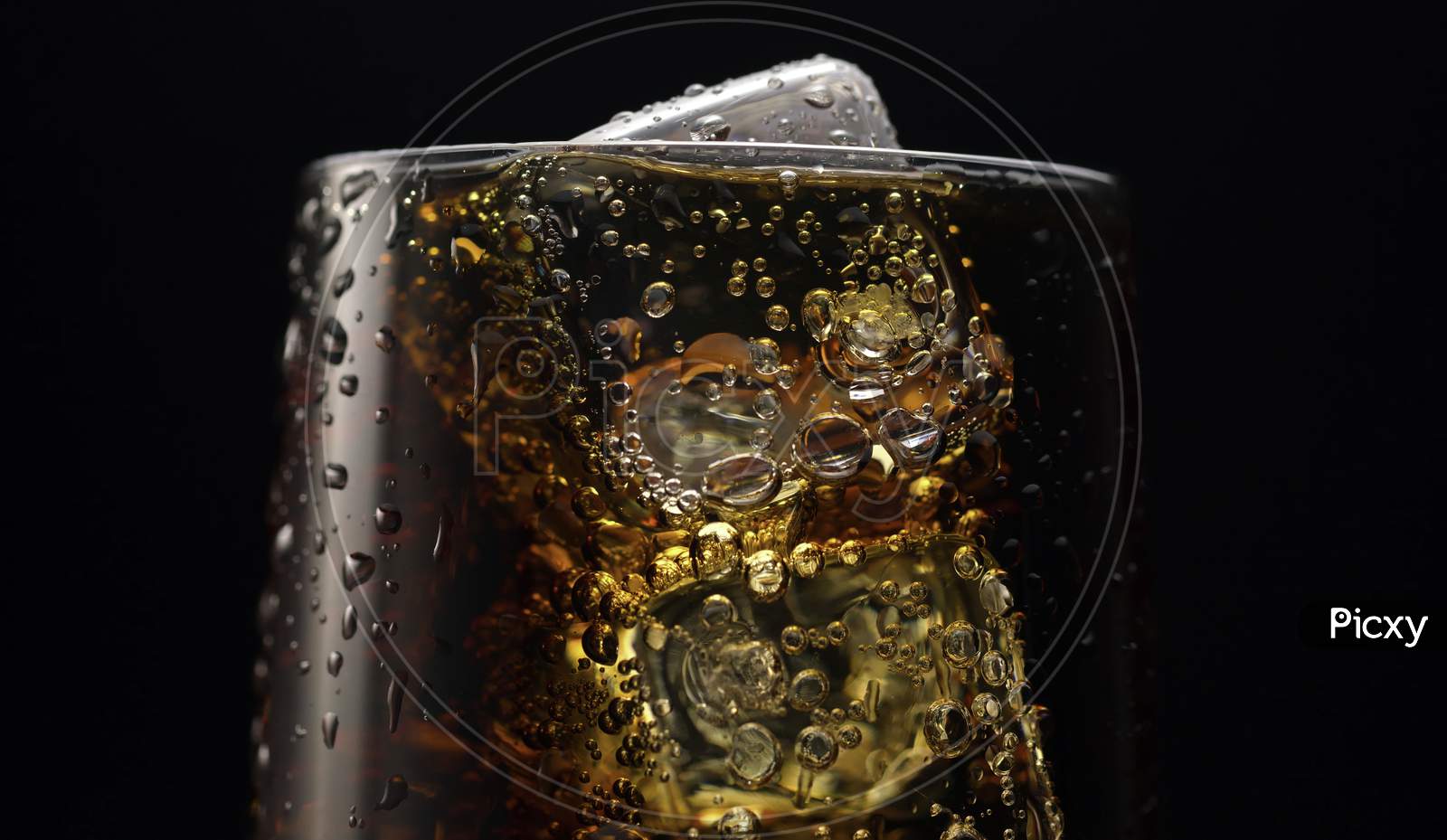 Soda and ice on black background.