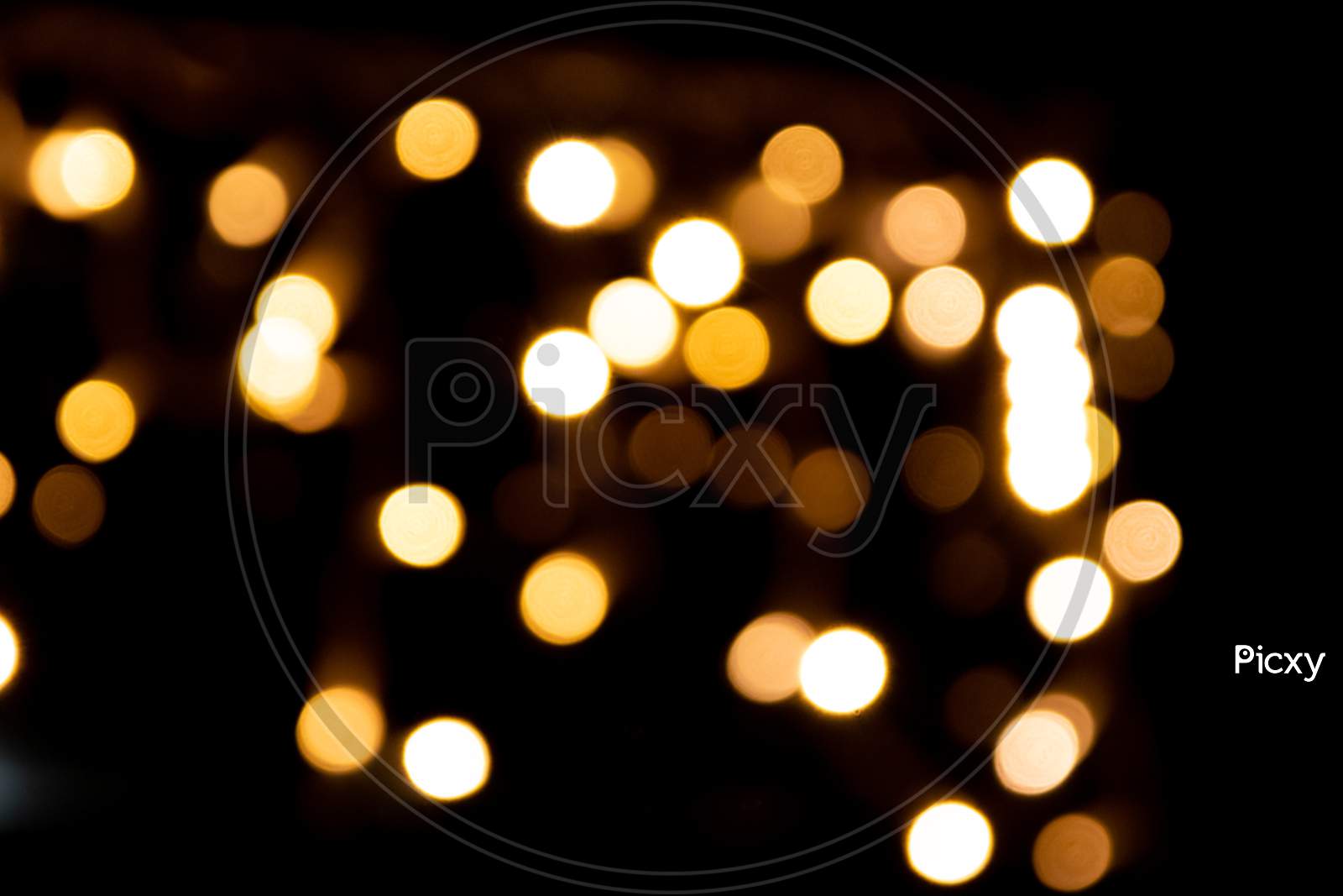 Shiny golden bokeh background for festive celebrations like christmas, silvester and a happy new year party as well as elegant invitation cards to celebrate with glitter rain and noble guests together