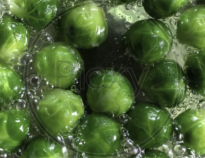 Shallow depth of field image of some peas in boiling water.