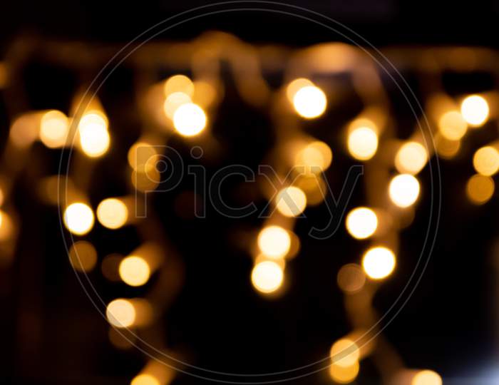 Shiny golden bokeh background for festive celebrations like christmas, silvester and a happy new year party as well as elegant invitation cards to celebrate with glitter rain and noble guests together