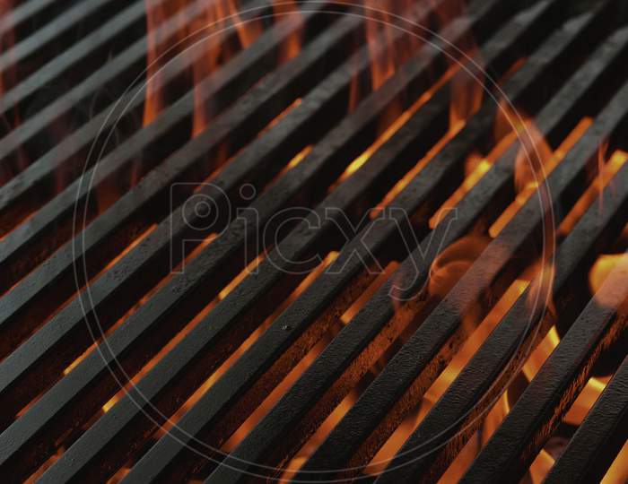 Blank Flaming BBQ Charcoal Grill, Closeup. Hot Barbeque Grill Ready Cooking Food On Cast Iron Grate. Concept For Cookout, Barbecue Party At Garden Or Backyard. Grill With Bright Flames Black Isolated.