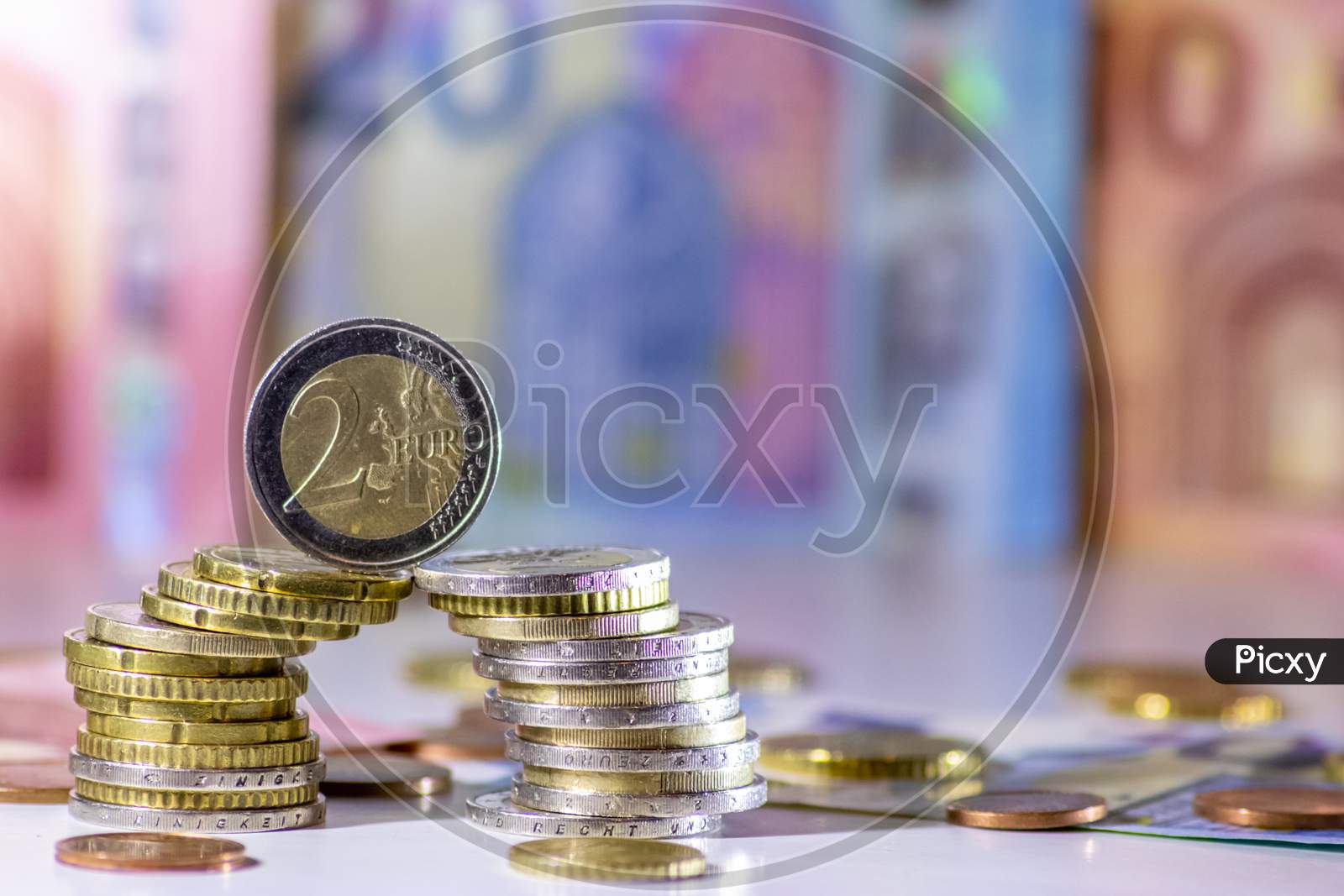 Bunch of european money with coins and bank notes show international finance with euro and europe, financial trade with a 2 euro coin and different euro coins and euro bank notes for financial success