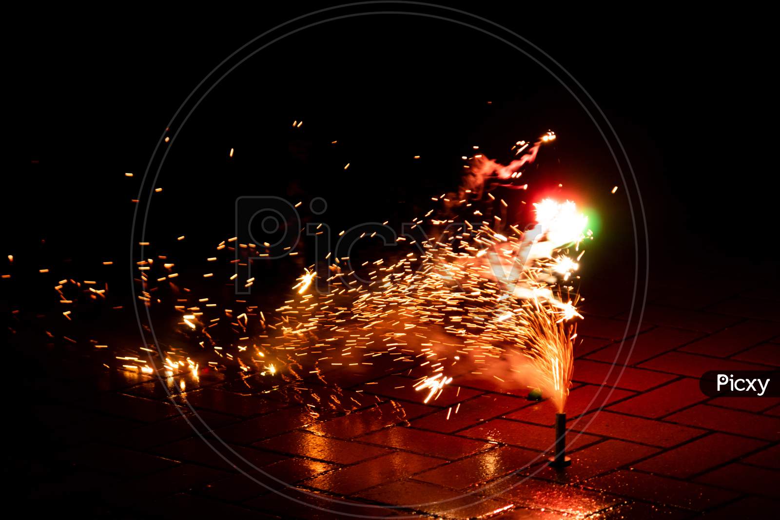 Colorful fireworks illuminates the silvester night with firecrackers, bangers and explosive pyrotechnics and fountains of light to celebrate into a happy new year on a silvester party with friends
