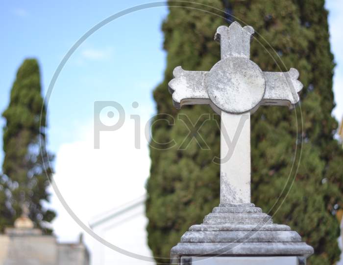 White Marble Cross In A Cemetery