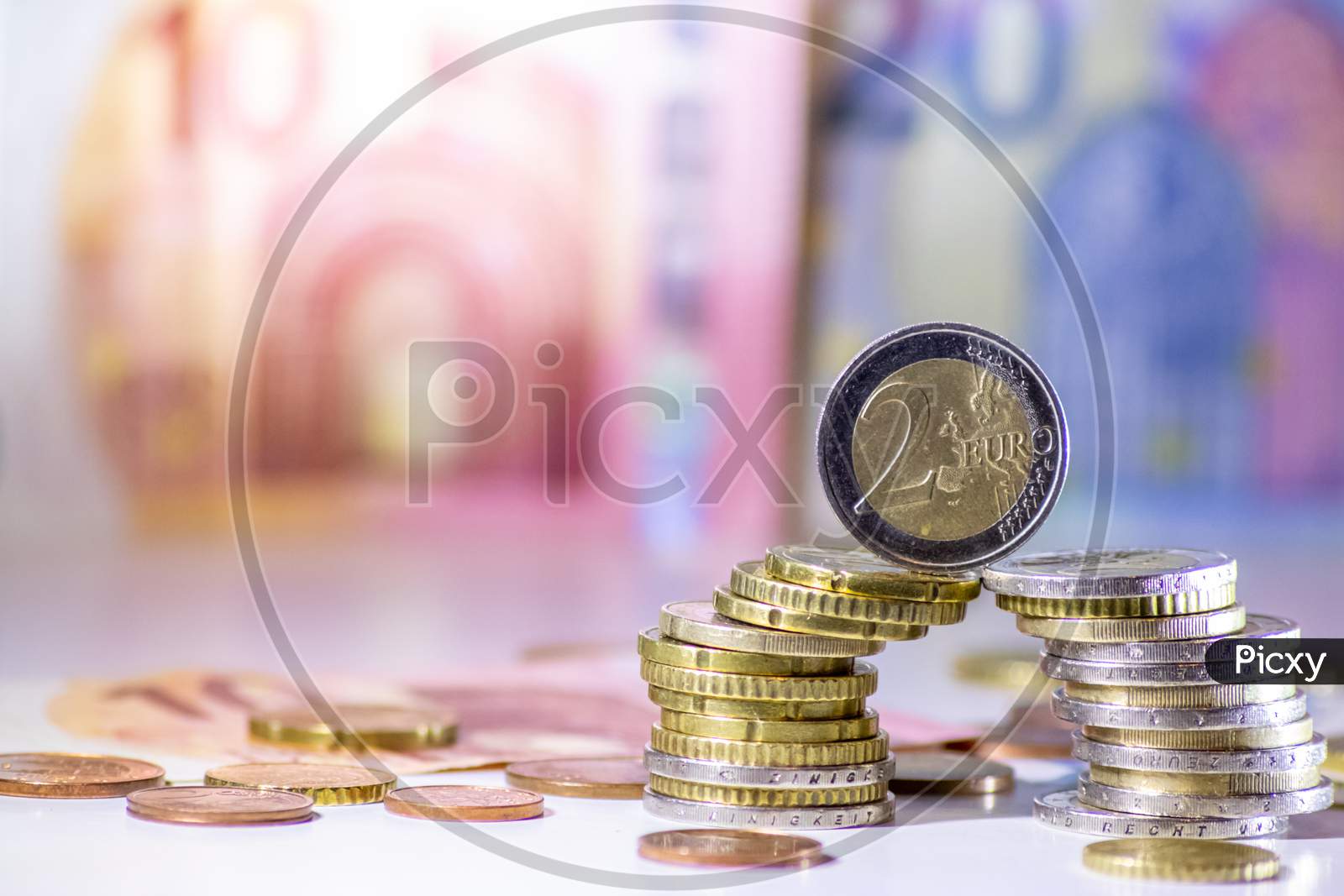 Bunch of european money with coins and bank notes show international finance with euro and europe, financial trade with a 2 euro coin and different euro coins and euro bank notes for financial success