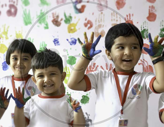 Indian Children drawing in the nursery . color in the hand of children.