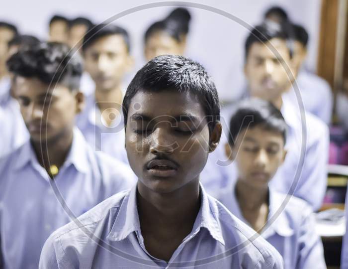 Group of Indian Government school boys students in uniform looking towards blackboard in the classroom of their school. Indian School Students