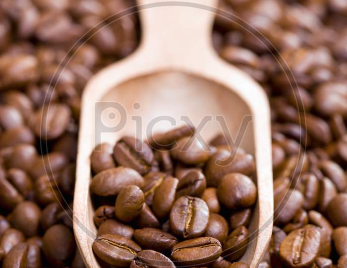 Coffee Beans On Wooden Scoop background