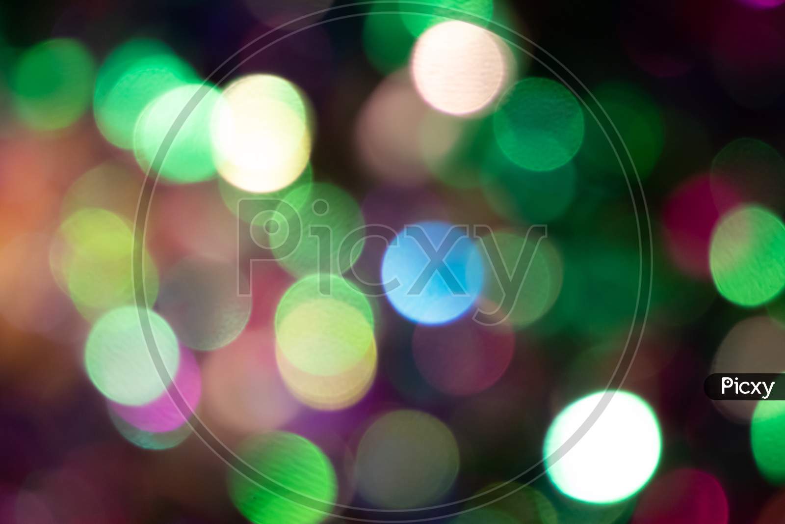 Festive colorful bokeh background with psychedelic colorful sparkles and colorful dots as perfect background for silvester, celebration and happy new year annotations as beautiful blurred glow