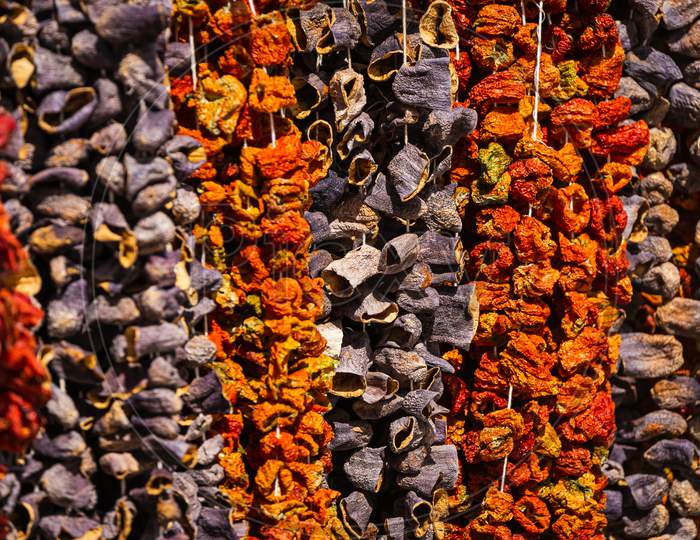 Close-Up Of Beautiful Rows Of Dried Chilli And Hot Peppers. Various Nuts On The Market Showcase