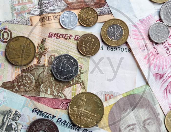 Variety of different bank notes and coins from various countries like euro, pound, emirates money, cyprus bank note and others represent the international market and global financial market