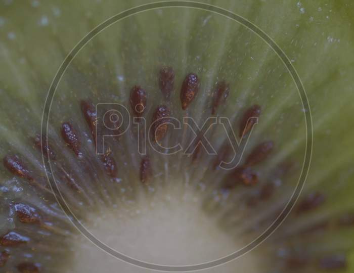 Kiwi fruit on wooden background. Kiwi cut in two halfs in a wooden table