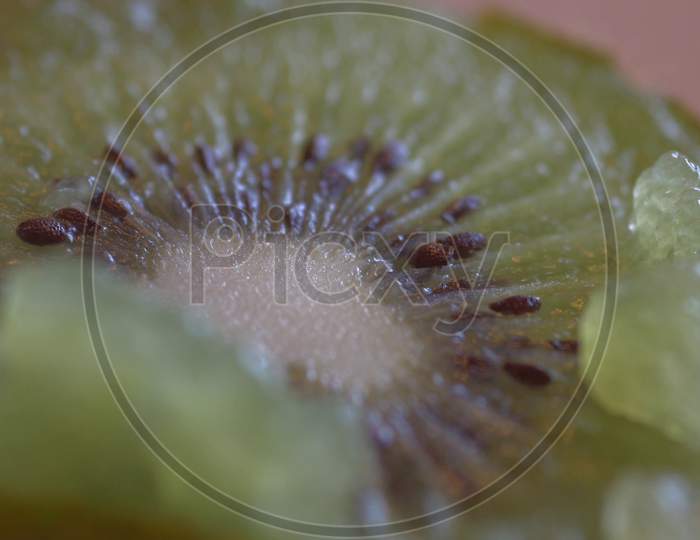 Kiwi fruit on wooden background. Kiwi cut in two halfs in a wooden table